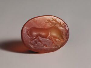 ancient roman carnelian intaglio of a boar under a tree