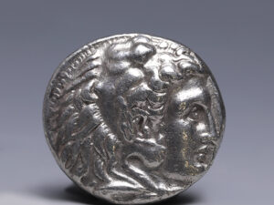 The Greek letter PΛ and KP are set in the filed at either side of the bird to indicate the mint.