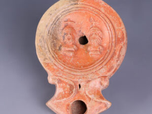 ancient roman oil lamp with cabiri