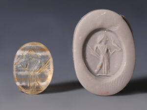 ancient roman intaglio of a figure holding a bird