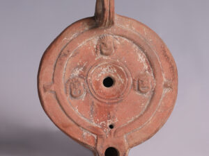 ancient roman terracotta oil lamp with faces