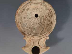 ancient roman terracotta oil lamp with grape and vines motif