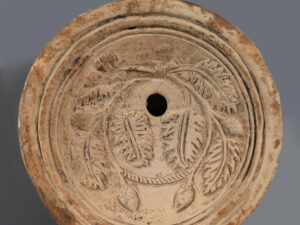 ancient roman terracotta oil lamp with grape and vines motif