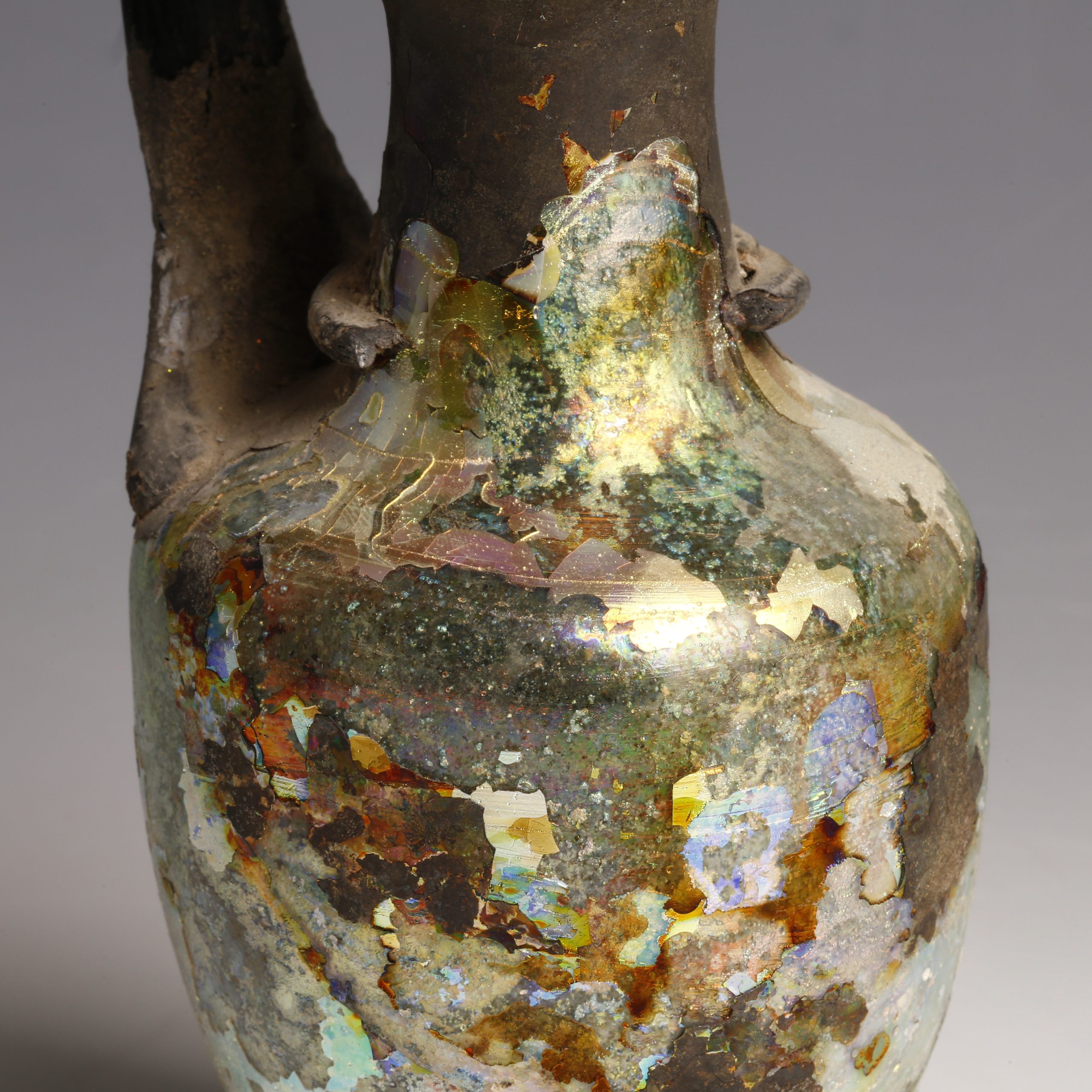 iridescent roman glass jug with handle close up iridescent roman glass jug with handle close up