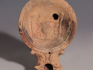 roman terracotta oil lamp with kanthros and herms