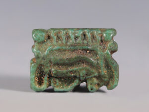 egyptian faience wedjat eye amulet surrounded by uraei