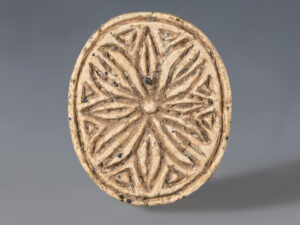 large egyptian steatite cowroid with floral pattern