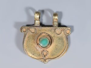 near eastern gold pendant with turquoise inset