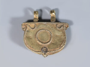 near eastern gold pendant with turquoise inset