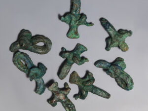 selection of bronze age bronze ram-head pendants